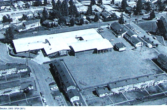 Decatur School as it looked in 1963, before Shearwater barracks buildings were cleared from the site and an addition built in 1966. The front door of the school building is on NE 43rd Street at the top of the photo. Courtesy of the Seattle Public Schools Archives #287-1.
